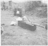 The coffin of a Vietnamese peasant   brought to the burial site by two men using a bamboo pole