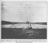 ONESTA HOLDING UP PIPE WHILE PRAYING TO THE BEAR SPEAR, WHICH HANGS FROM THE TRIPOD.